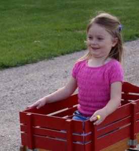 Little_girl_in_red_wagon_by_eyenoticed